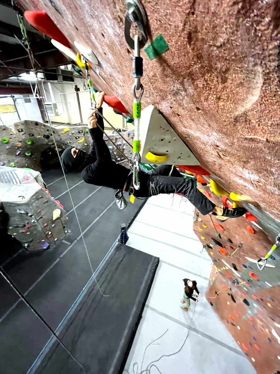 Looking up the lead wall at a climber on rope