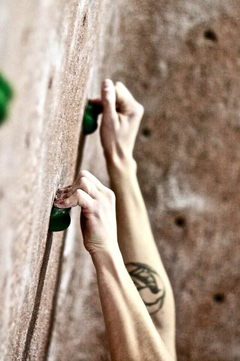 Chalked hand gripping a hold