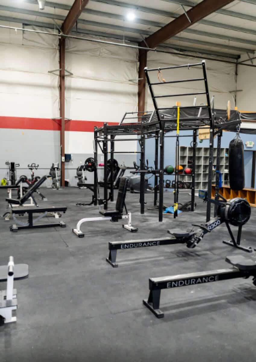 Weight room with racks, benches and free weights