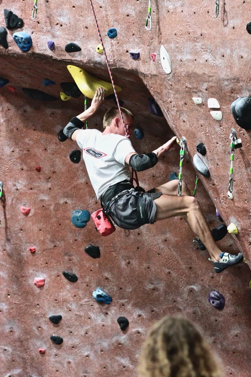 Climber on a roped route on the lead wall