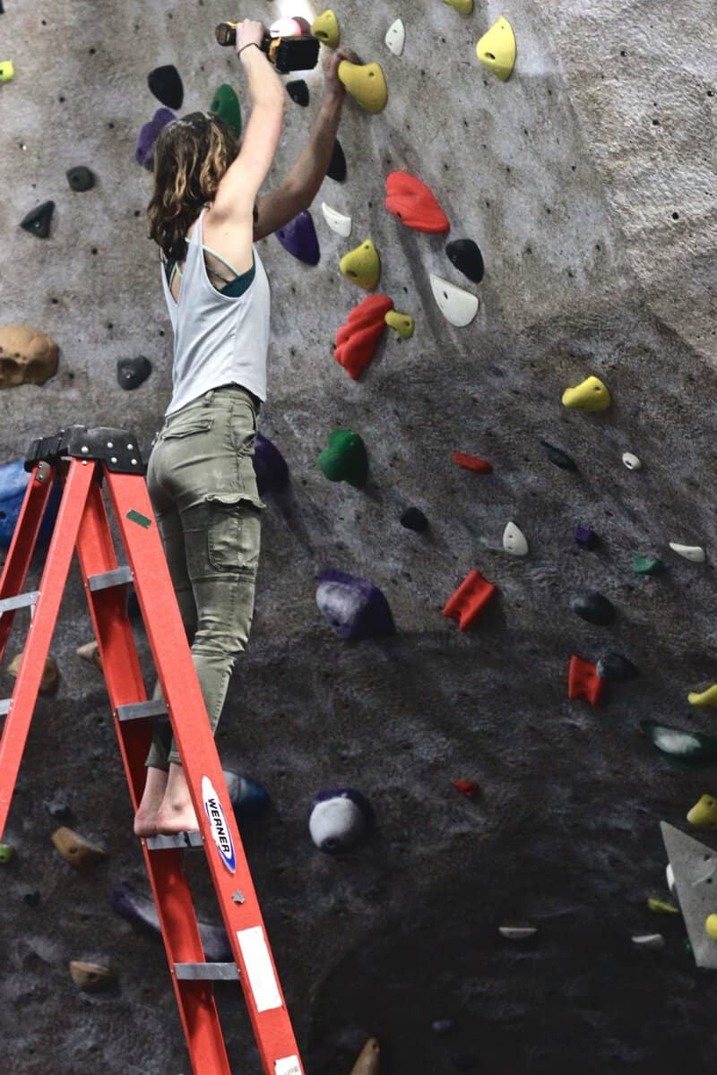 Staff member setting a route from a ladder