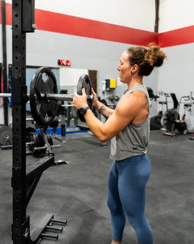 Member training on a cable machine in the weight room